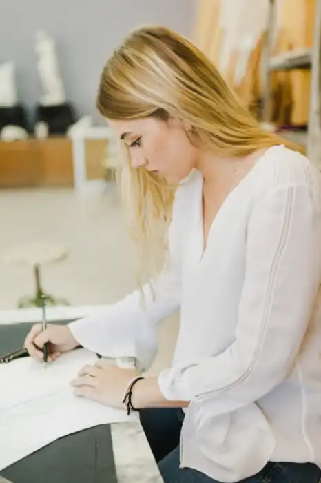 side-young-woman-sketching-paper-with-pencil-workbench